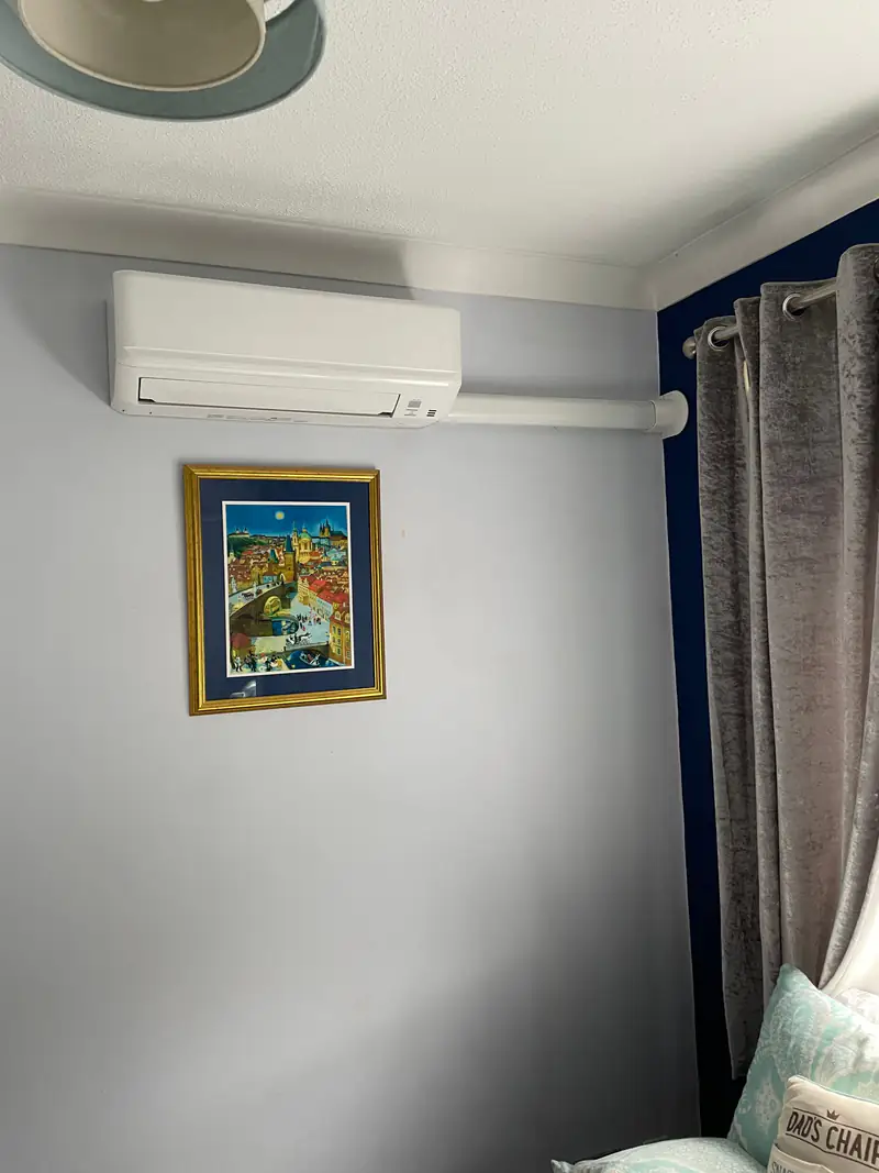 Air conditioning in Sherburn in Elmet Wall-mounted air conditioning unit in a living room with framed artwork in a Sherburn in Elmet new-build