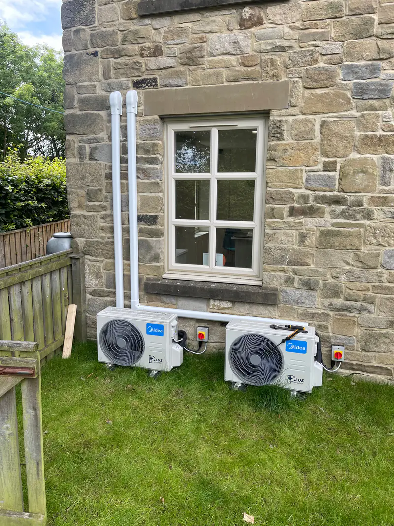 Air conditioning in York Two outdoor air conditioning units placed discreetly at the rear of a stone-built property, an approach suited to York's period buildings