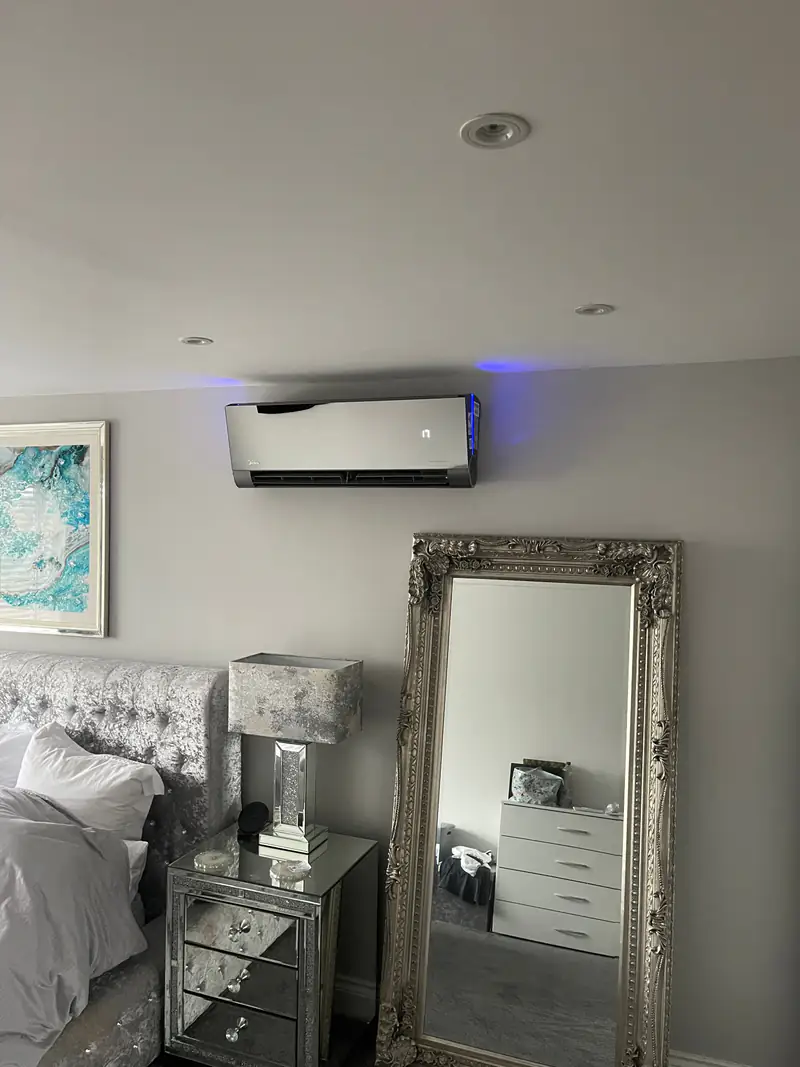 Bedroom air conditioning in Clifton, York Dark-finish air conditioning unit in a bedroom with a full-length mirror, suited to Clifton's Victorian and Edwardian homes