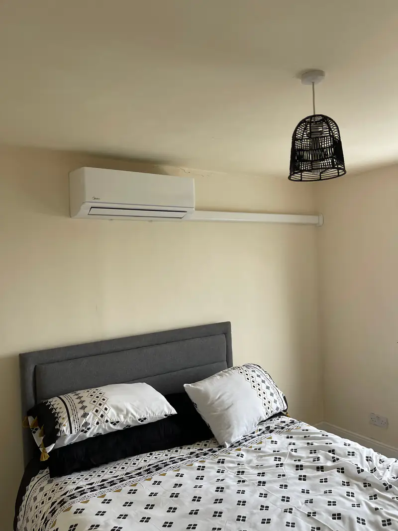 Bedroom air conditioning in Strensall Quiet white air conditioning unit high on the wall of a bedroom in a Strensall village home