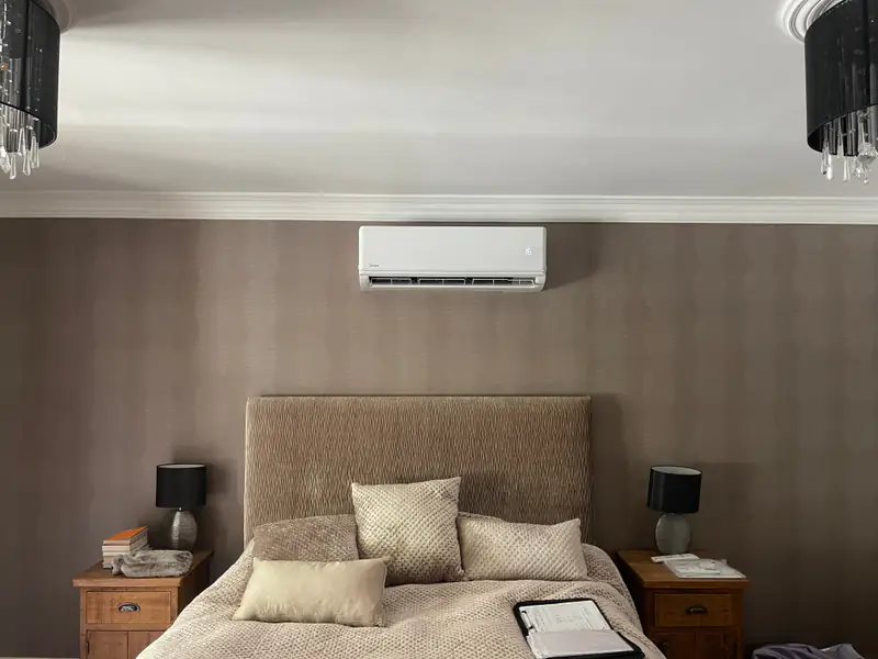 Bedroom air conditioning in York Wall-mounted air conditioning unit positioned above the bed in a calm York bedroom